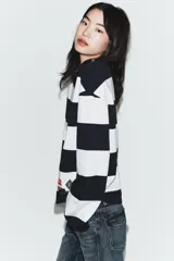 Camiseta de manga larga con cuello redondo, confeccionada en algodón, con patrón de rayas horizontales anchas en azul marino y blanco. Presenta dos etiquetas rectangulares cosidas en la parte inferior delantera.