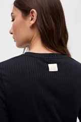 Remera de manga larga con cuello redondo, confeccionada en tejido rib con textura acanalada y calce ajustado al cuerpo.