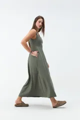 Vestido midi negro con escote cuadrado, tirantes anchos y falda de corte acampanado.