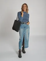 Falda de jean midi de tiro alto, con cinco bolsillos y abertura frontal en el bajo. Presenta un lavado medio y ruedo sin costura.