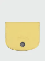 Tarjetero de cuero color amarillo, modelo Le Pliage Xtra de Longchamp, con diseño plegable y cierre de botón a presión.