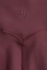 Leggings deportivas de tiro alto, color bordó, con cintura ancha. Confeccionadas en tejido funcional SoftMove™ y DryMove™.
