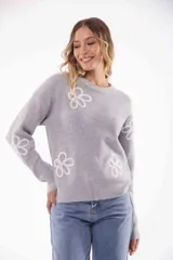 Sweater gris de punto con cuello redondo y flores blancas bordadas.