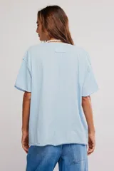 Remera de algodón celeste, de corte oversize con escote en V amplio y mangas cortas caídas.