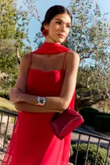Vestido largo rojo de fiesta con escote palabra de honor y capa superpuesta en el pecho, de corte recto y ajustado.