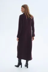 Vestido midi color bordó, con cuello camisero y tapeta con botones ocultos, de manga larga con puños anchos abotonados y corte holgado.