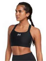Top deportivo de alto impacto Under Armour, color negro, con tecnología HeatGear® que absorbe el sudor. Presenta diseño de compresión, correas ajustables con cierre de gancho y logo de la marca estampado en el centro.