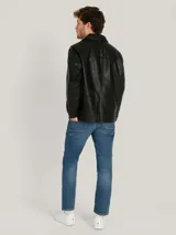 Campera clásica de poliuretano color negro para hombre, de marca Tommy Hilfiger. Posee cuello camisero, cierre frontal con cremallera, bolsillos frontales y puños ajustables.