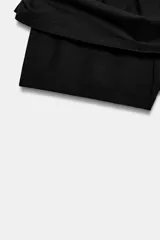 Falda corta gris melange de tiro medio con cintura elástica, confeccionada en hilatura con mezcla de algodón. Cuenta con forro interior tipo shorts del mismo tejido.