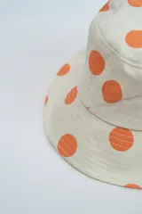 Gorro tipo bucket color crema con estampado de lunares en color verde menta.