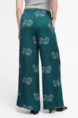 Pantalón ancho de seda viscosa color verde petróleo con estampado de tigres blancos. Cuenta con bolsillos laterales y elástico en la cintura.