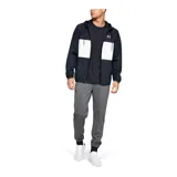 Pantalón de jogging Under Armour, color gris jaspeado, con cintura elástica ajustable con cordón, puños en los tobillos y bolsillos laterales con cierre. Presenta el logo de la marca estampado en la pierna derecha.