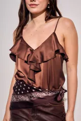 Musculosa de satén color marrón, con escote en V, tirantes finos y detalle de volados frontales.