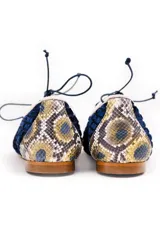 Zapato tipo blucher de terciopelo de seda azul marino con diseño rayado. Presenta una abertura central ajustable con cordones, ribetes en contraste y detalles en piel con estampado de pitón multicolor en la puntera y el talón. Cuenta con suela de cuero.