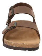 Sandalias de cuero color café RKF modelo Commet, con diseño de doble tira ajustable con hebilla metálica y tira trasera en el talón. Cuenta con base anatómica de corcho y suela de goma.
