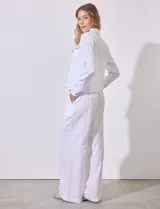 Camisa tipo campera de lino marca Dash, color blanco, con cierre frontal de botones, cuello camisero y bolsillos con solapa en el pecho.