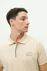 Polo de manga corta Brooksfield en color azul marino con textura. Presenta cuello clásico con cierre de botones, logo estampado en el pecho y detalles en contraste en el borde del cuello y las mangas.