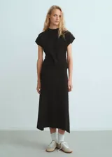 Jersey de punto fino color negro, con cuello redondo, manga corta y diseño entallado.