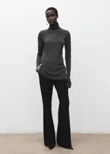 Jersey de cuello alto gris oscuro, de manga larga y corte ajustado.