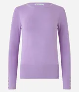 Suéter de punto color rosado, con cuello barco, mangas largas y puños con botones decorativos. El dobladillo también es acanalado.