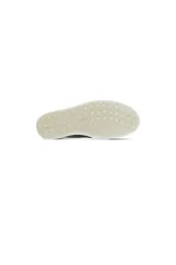 Zapatillas Ecco Soft 7 sin cordones, de cuero negro con textura y suela blanca de goma.