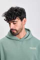 Canguro deportivo color verde menta con capucha, bolsillo canguro y estampado frontal con el texto "Pulse Mode" y "Data/Control/Flow" en blanco.