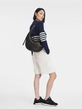 Bolso de hombro tipo hobo de la línea Roseau Essential de Longchamp, confeccionado en cuero vacuno con textura granulada. Presenta una silueta curva, cierre superior con cremallera y el distintivo cierre de bambú metálico de la marca en el lateral.