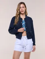 Camperita bomber de lyocell con textura suave, color azul marino, cuello camisero, cierre frontal con botones a presión, bolsillos laterales con solapa, mangas largas con puños elásticos y pretina fruncida en el ruedo.