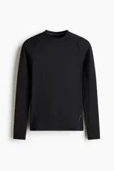 Remera deportiva de manga larga raglán con cuello redondo, confeccionada en tejido funcional DryMove con tecnología de compresión para soporte muscular y costuras planas antifricción.