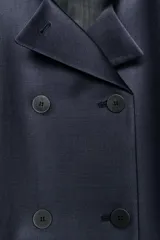 Blazer entallada de Zara Woman Collection, color azul marino, con cuello subido y detalle de tejido a contraste. Presenta cierre frontal cruzado con botones, manga larga y bolsillos con solapa en el delantero. Incluye forro interior.