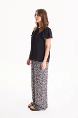 Pantalón de viscosa con estampado animal print tipo cebra, corte recto y cintura elastizada.