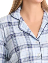 Conjunto de pijama de dos piezas con estampado animal print. La parte superior es una camisa de manga larga con cuello solapa, escote en V, cierre frontal con botones y bolsillo aplicado. El pantalón cuenta con cintura elástica y lazo de ajuste.