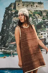 Vestido corto sin mangas, de tejido de punto en color azul marino con efecto jaspeado o tweed en tonos claros. Presenta un corte amplio y relajado, con cuello redondo y bordes en contraste.