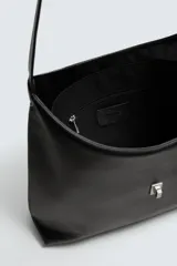 Bolso de hombro negro, de diseño liso y minimalista, con cierre metálico en el compartimento principal y un bolsillo interior con cremallera.