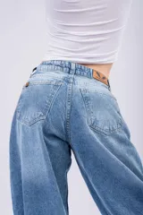 Jean de corte baggy con tiro bajo, diseño holgado y pierna ancha, confeccionado en denim de tono azul medio.