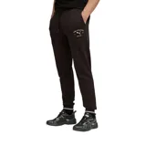 Pantalón de jogging Puma color negro, con cintura elástica ajustable mediante cordón, puños acanalados en los tobillos con detalle de rayas y logo de la marca estampado en el muslo.
