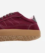 Championes estilo chutera color bordó, con recortes pespunteados, cordones con detalles contrastantes y suela de goma color caramelo.