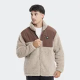 Campera de polar tipo sherpa en color beige, con paneles superiores en color azul grisáceo. Presenta cuello alto, cierre frontal completo y un bolsillo en el pecho con cierre y logo de la marca.