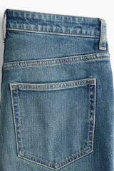 Jean de tiro alto y pierna recta confeccionado en denim de algodón con un leve porcentaje de stretch, de cinco bolsillos y diseño clásico en color azul con efecto deslavado.
