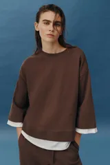 Sudadera de algodón color marrón con efecto doble capa, con cuello redondo y detalles en tejido blanco a contraste en las mangas y el bajo asimétrico.