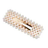 Set de dos broches dorados para el pelo, decorados con perlas sintéticas.