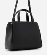 Cartera satchel mediana de Satinato en color negro, confeccionada en poliuretano. Posee estructura firme, doble asa de mano superior y correa larga ajustable para llevar al hombro o cruzada. Cuenta con un bolsillo frontal con cierre y detalles metálicos dorados.
