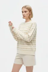 Sweater de punto color blanco con diseño de rayas horizontales doradas, cuello redondo y manga larga.