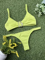 Conjunto de bikini color lima con textura, compuesto por un top triangular con detalle de hebilla metálica plateada en el centro y bombacha colaless.