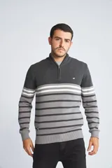 Sweater de punto para hombre con diseño de rayas horizontales en tonos azul marino, azul y mostaza. Presenta cuello alto con medio cierre frontal, mangas largas con puños acanalados y logo bordado en el pecho.