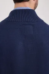 Cardigan de tejido de punto color azul piedra melange, con cuello mao y cierre frontal de botones.