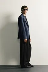 Blazer regular fit azul marino confeccionado en tejido con elasticidad, con cuello de solapas de muesca, cierre frontal con botones y bolsillos con solapa en la cadera.
