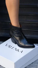 Botas cortas de cuero negro con diseño de estilo western, punta fina y taco cuadrado de 5.5 cm. Cuentan con cierre lateral y suela de goma.