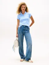 Chomba de algodón y elastano color celeste claro, de corte slim, con cuello tipo polo y cartera de dos botones. Presenta el logo script de Tommy Hilfiger bordado en el pecho y la bandera de Tommy Hilfiger bordada en la manga.