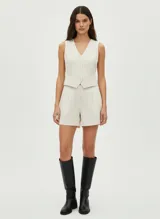 Short de tiro alto color crema confeccionado en tejido liviano de viscosa y lino. Presenta pinzas frontales que aportan estructura y un calce cómodo. Su corte clásico y su largo medio los convierten en una prenda ideal para el verano o los días de entretiempo.